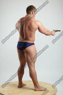 ADAM WARD STANDING WITH TWO GUNS